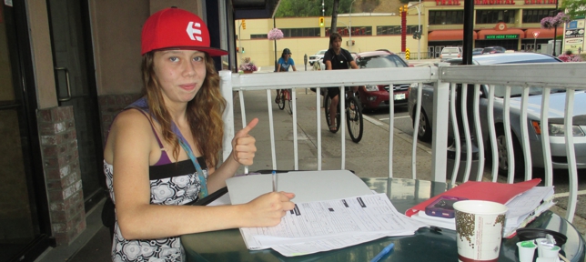 Young lady fills out application OTDC forms.